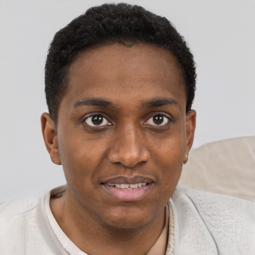 Joyful black young-adult male with short  brown hair and brown eyes