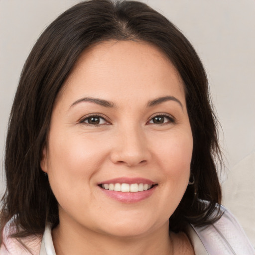 Joyful white young-adult female with medium  brown hair and brown eyes