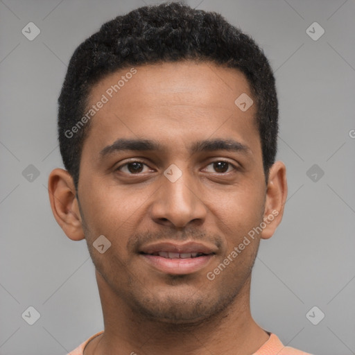 Joyful black young-adult male with short  brown hair and brown eyes