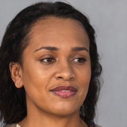 Joyful black young-adult female with medium  brown hair and brown eyes