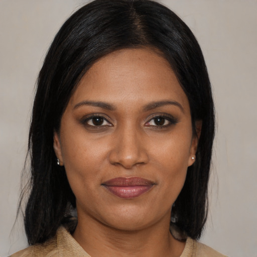 Joyful black young-adult female with medium  brown hair and brown eyes