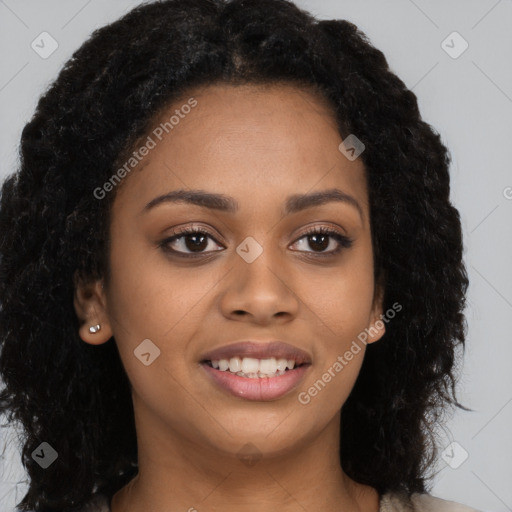 Joyful black young-adult female with long  black hair and brown eyes