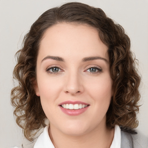 Joyful white young-adult female with medium  brown hair and green eyes