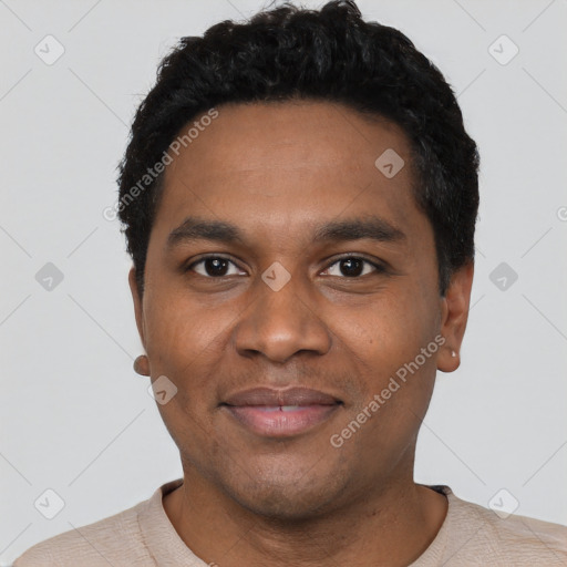 Joyful black young-adult male with short  black hair and brown eyes