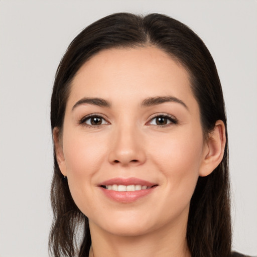 Joyful white young-adult female with long  brown hair and brown eyes