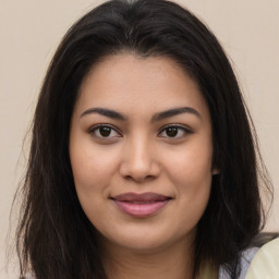 Joyful asian young-adult female with long  brown hair and brown eyes