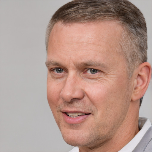 Joyful white middle-aged male with short  brown hair and brown eyes