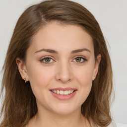 Joyful white young-adult female with long  brown hair and green eyes