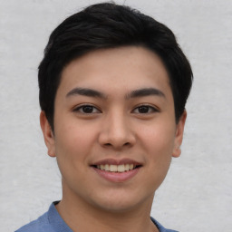 Joyful asian young-adult male with short  black hair and brown eyes