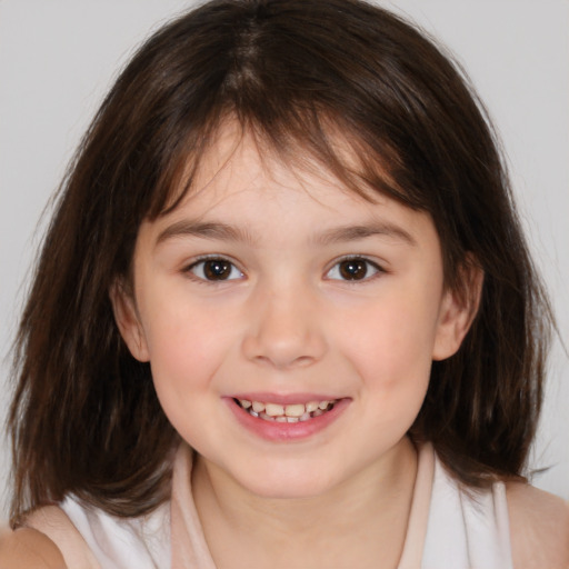 Joyful white child female with medium  brown hair and brown eyes