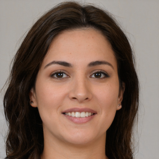 Joyful white young-adult female with long  brown hair and brown eyes