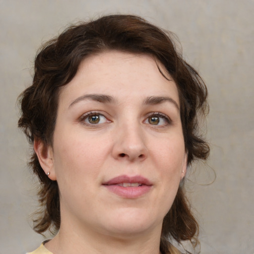 Joyful white young-adult female with medium  brown hair and green eyes