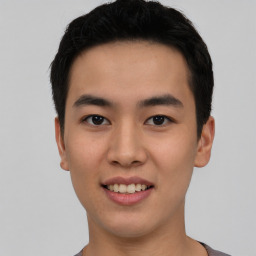 Joyful asian young-adult male with short  black hair and brown eyes