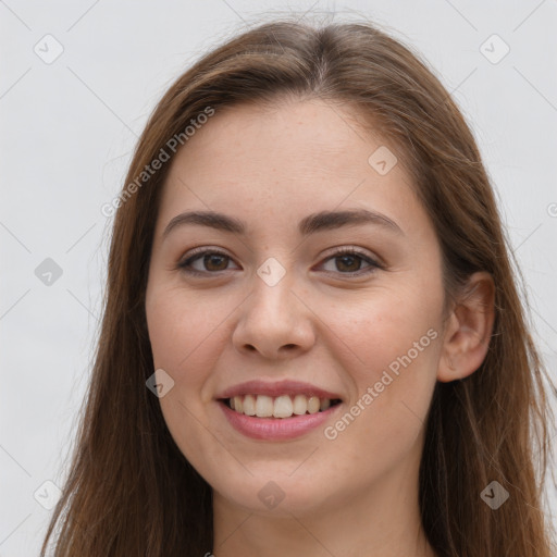 Joyful white young-adult female with long  brown hair and grey eyes