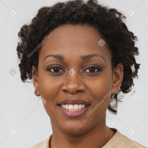 Joyful black adult female with short  brown hair and brown eyes