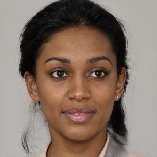 Joyful black young-adult female with medium  brown hair and brown eyes