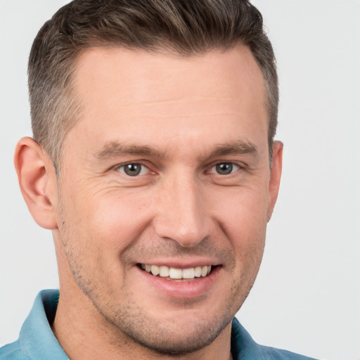 Joyful white adult male with short  brown hair and brown eyes