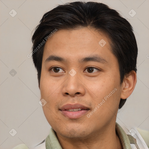 Joyful asian young-adult male with short  brown hair and brown eyes