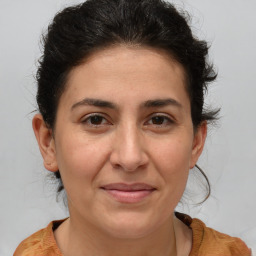 Joyful white adult female with medium  brown hair and brown eyes