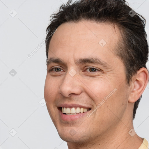 Joyful white adult male with short  brown hair and brown eyes