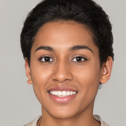 Joyful latino young-adult female with short  brown hair and brown eyes