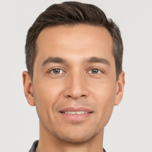 Joyful white young-adult male with short  brown hair and brown eyes