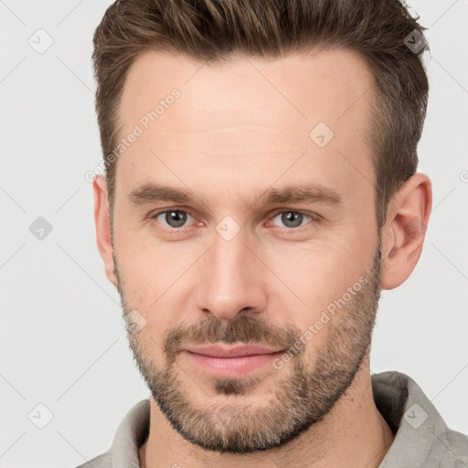 Joyful white young-adult male with short  brown hair and brown eyes