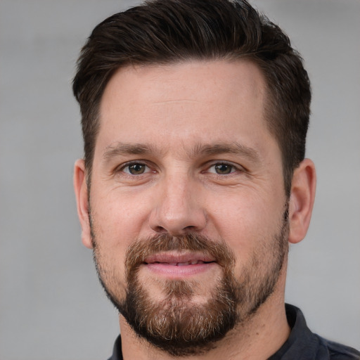 Joyful white adult male with short  brown hair and brown eyes