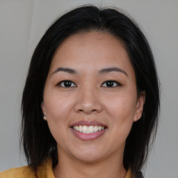 Joyful asian young-adult female with medium  brown hair and brown eyes