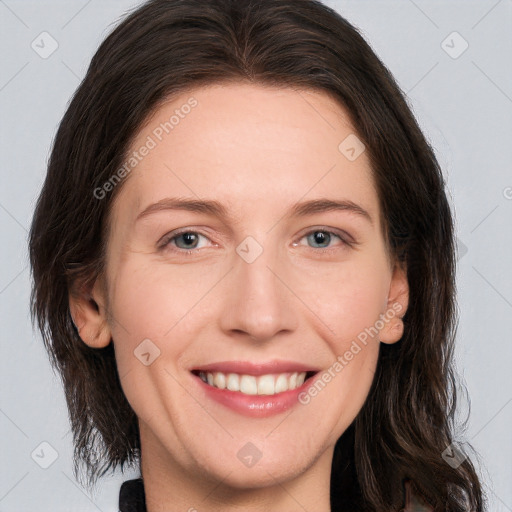 Joyful white adult female with long  brown hair and brown eyes