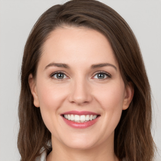 Joyful white young-adult female with long  brown hair and grey eyes