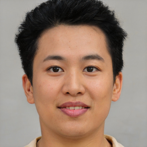 Joyful asian young-adult male with short  brown hair and brown eyes