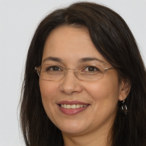 Joyful white adult female with long  brown hair and brown eyes