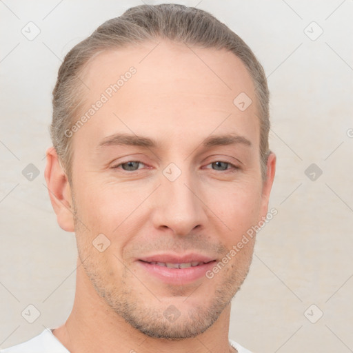 Joyful white young-adult male with short  brown hair and grey eyes