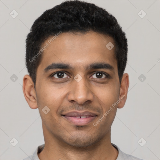 Joyful latino young-adult male with short  black hair and brown eyes