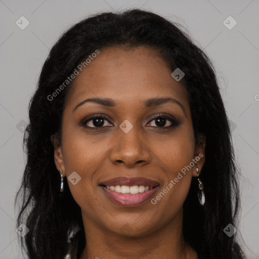 Joyful black young-adult female with long  brown hair and brown eyes