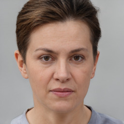 Joyful white adult female with short  brown hair and brown eyes