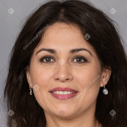 Joyful white adult female with long  brown hair and brown eyes