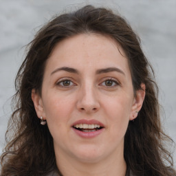 Joyful white adult female with long  brown hair and grey eyes