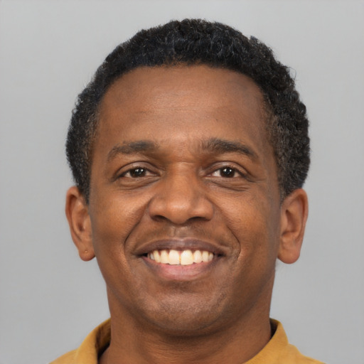 Joyful latino adult male with short  brown hair and brown eyes