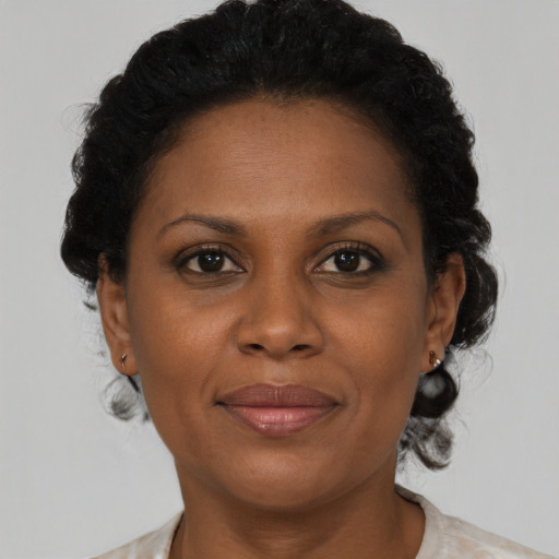 Joyful black adult female with medium  brown hair and brown eyes