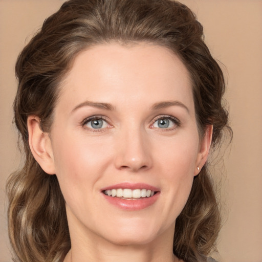 Joyful white young-adult female with medium  brown hair and green eyes