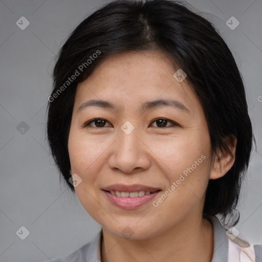 Joyful asian adult female with medium  brown hair and brown eyes