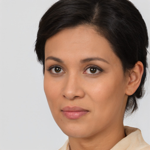 Joyful latino young-adult female with medium  brown hair and brown eyes