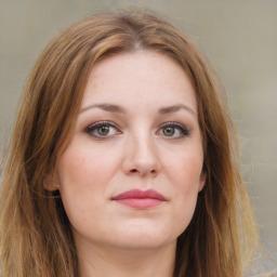 Joyful white young-adult female with long  brown hair and green eyes