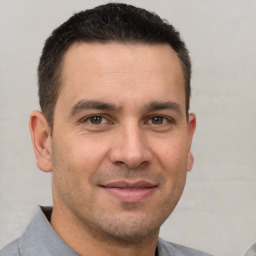 Joyful white adult male with short  brown hair and brown eyes