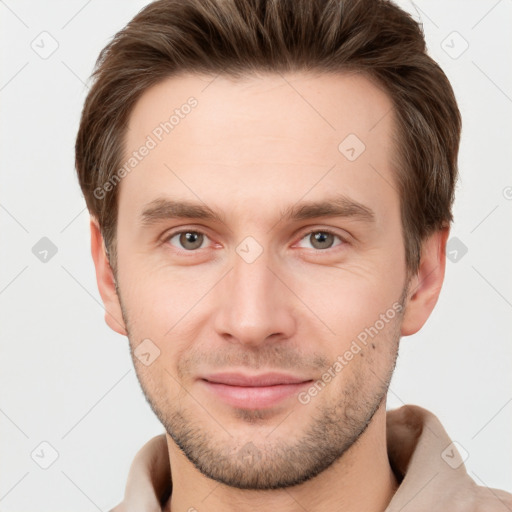 Joyful white young-adult male with short  brown hair and grey eyes