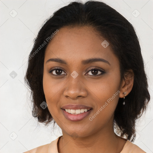 Joyful black young-adult female with long  brown hair and brown eyes