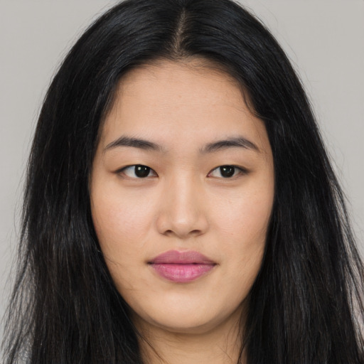 Joyful asian young-adult female with long  black hair and brown eyes