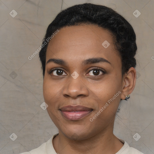 Joyful black young-adult female with short  black hair and brown eyes
